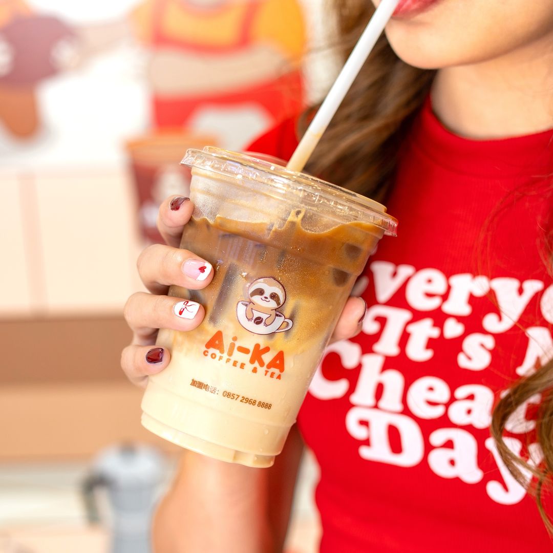 A woman enjoying Ai-Latte Osmanthus from Ai-KA Coffee & Tea