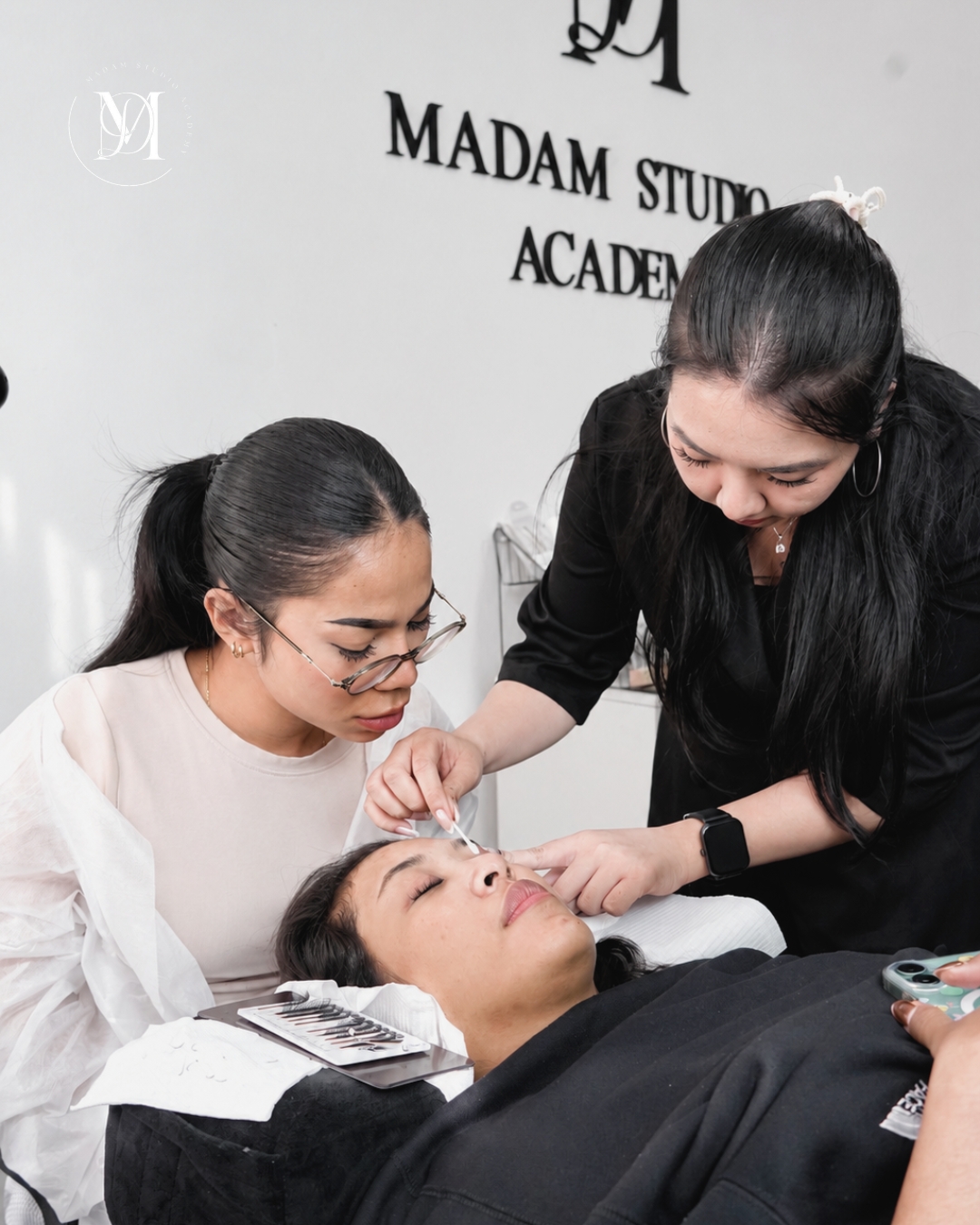 Student practicing eyelash extensions during a beginner lash training course.