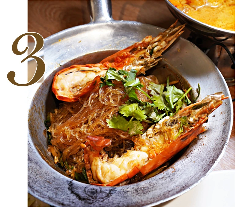 Premium Baked Jumbo River Prawns with Vermicelli in a traditional metal pot, featuring large river prawns, seasoned glass noodles, and fresh coriander garnish, a signature dish at Hua Seng Hong.