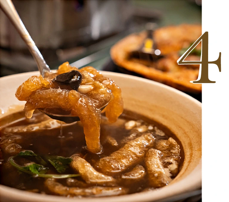 A close-up of a premium Fish Maw Stew with Crab Meat in a thick brown soup being scooped with a spoon, showing the tender fish maw and fresh crab meat in a white bowl at Hua Seng Hong restaurant.