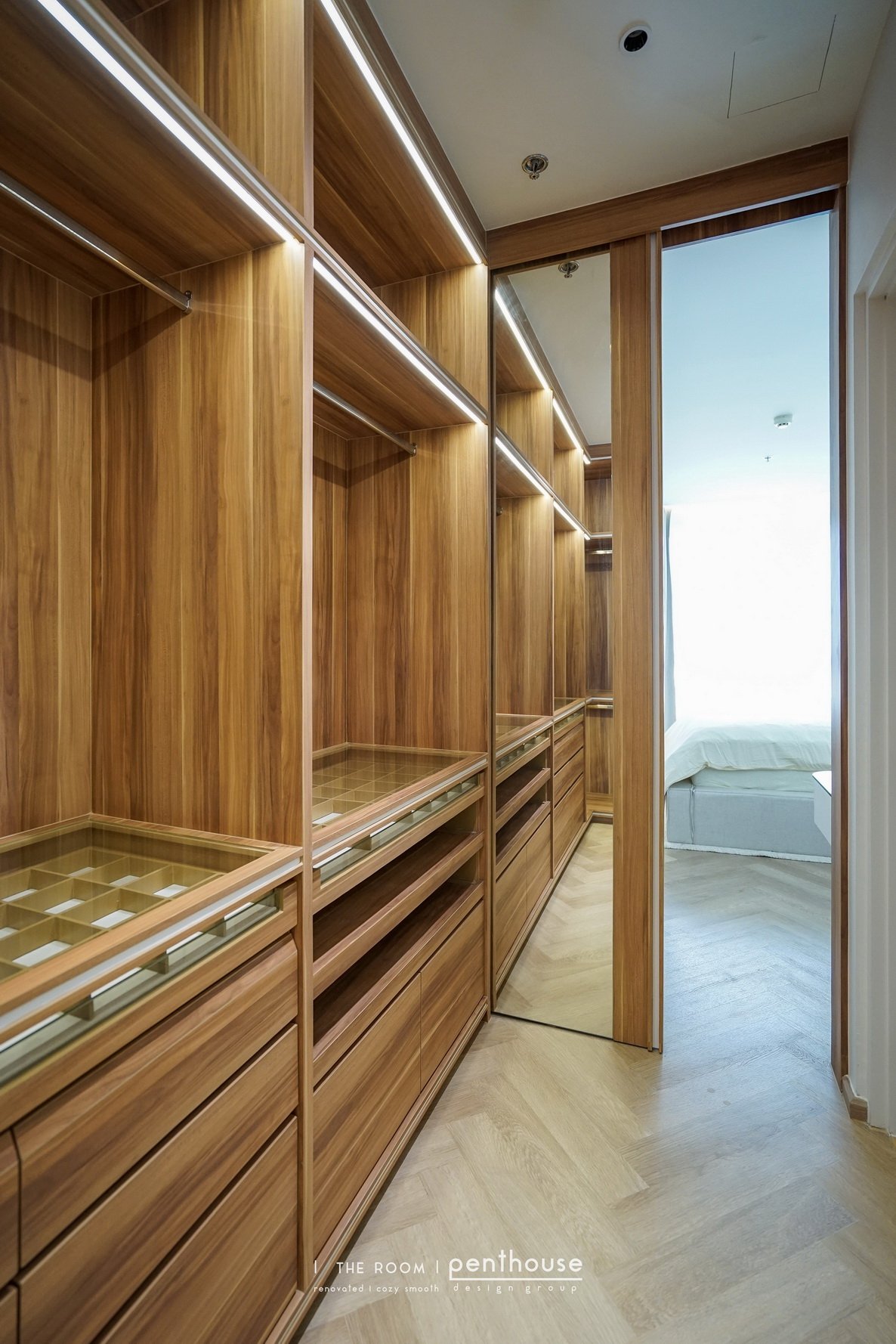 Wardrobe storage at The Room Sathorn with hanging rails, drawers and divided compartments