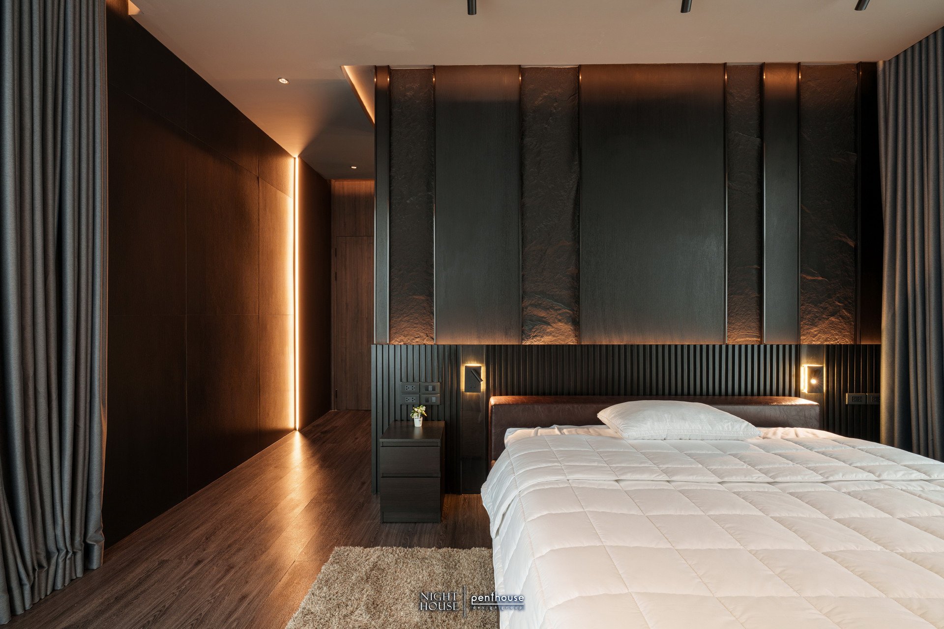 Completed Night House bedroom showing bedside fittings, headboard-wall lighting and a light line near the entrance