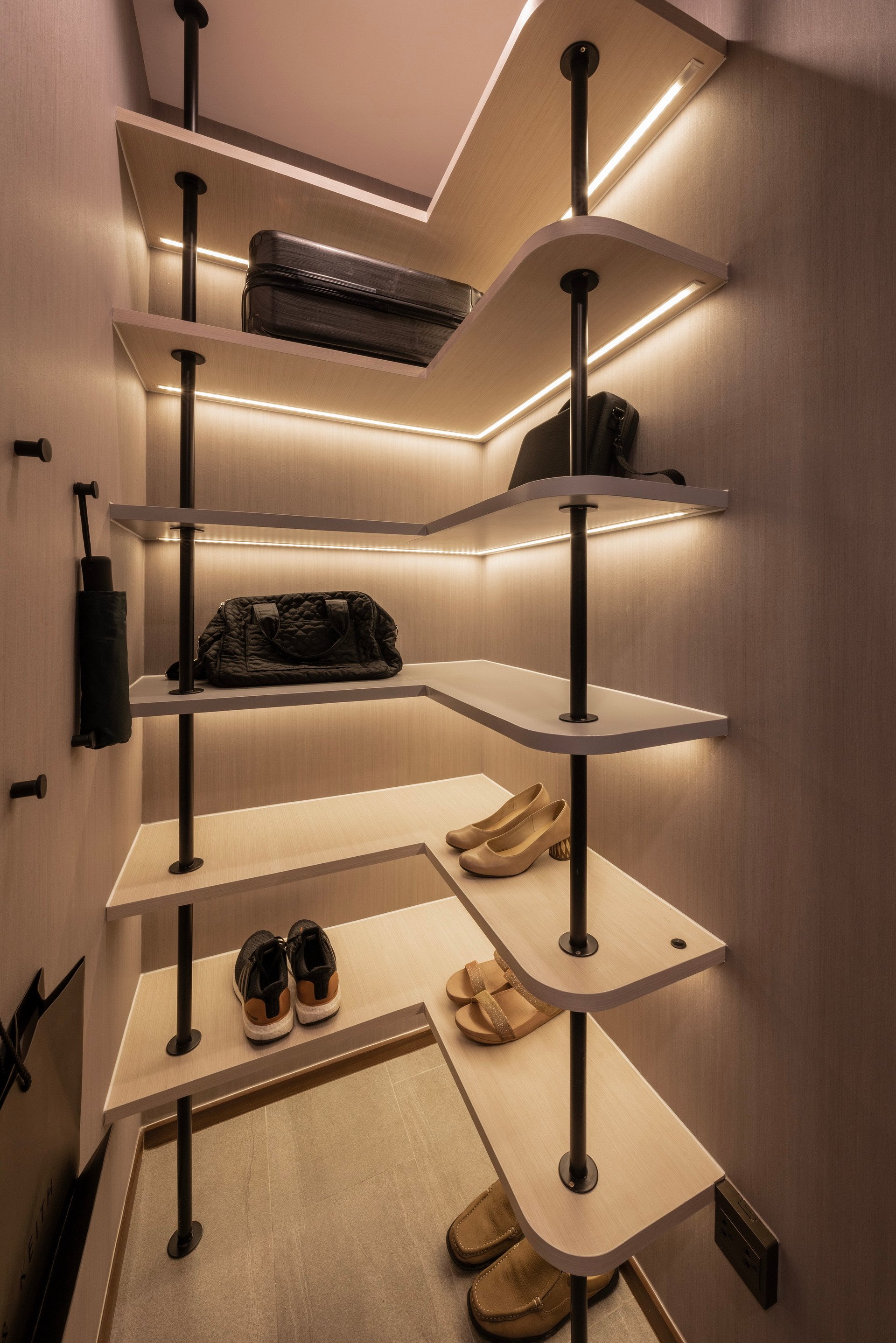 Completed Ideo Q Victory shelves displaying shoes and bags in separate wall compartments