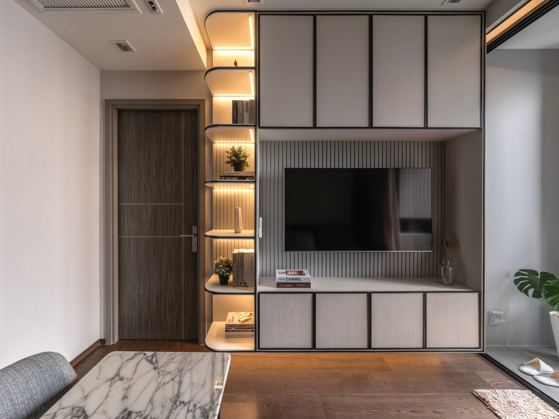 Completed Ideo Q Victory television wall with upper and lower cabinets and open corner shelving