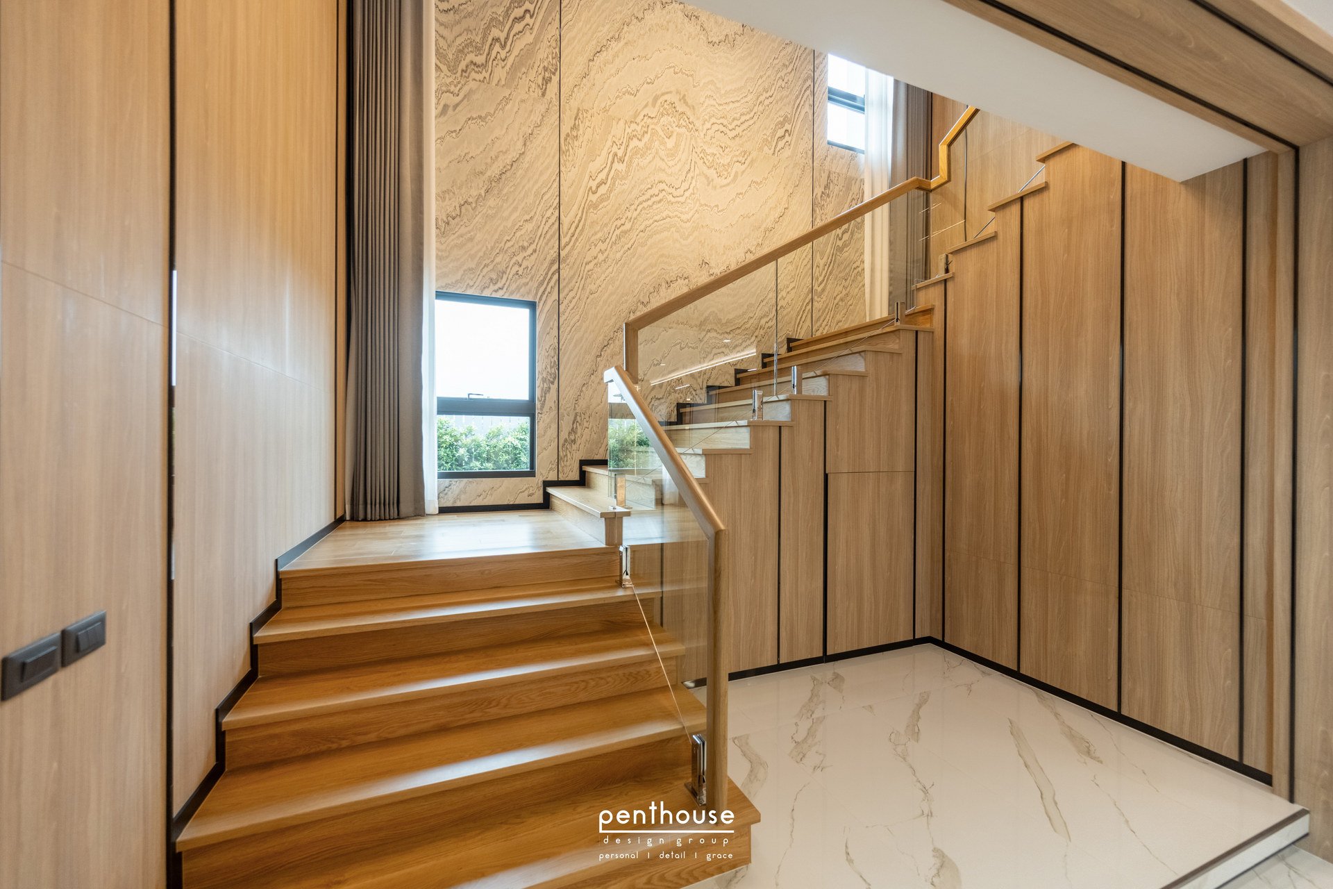 Real Theera House staircase with adjacent cabinetry, glass guarding and a window