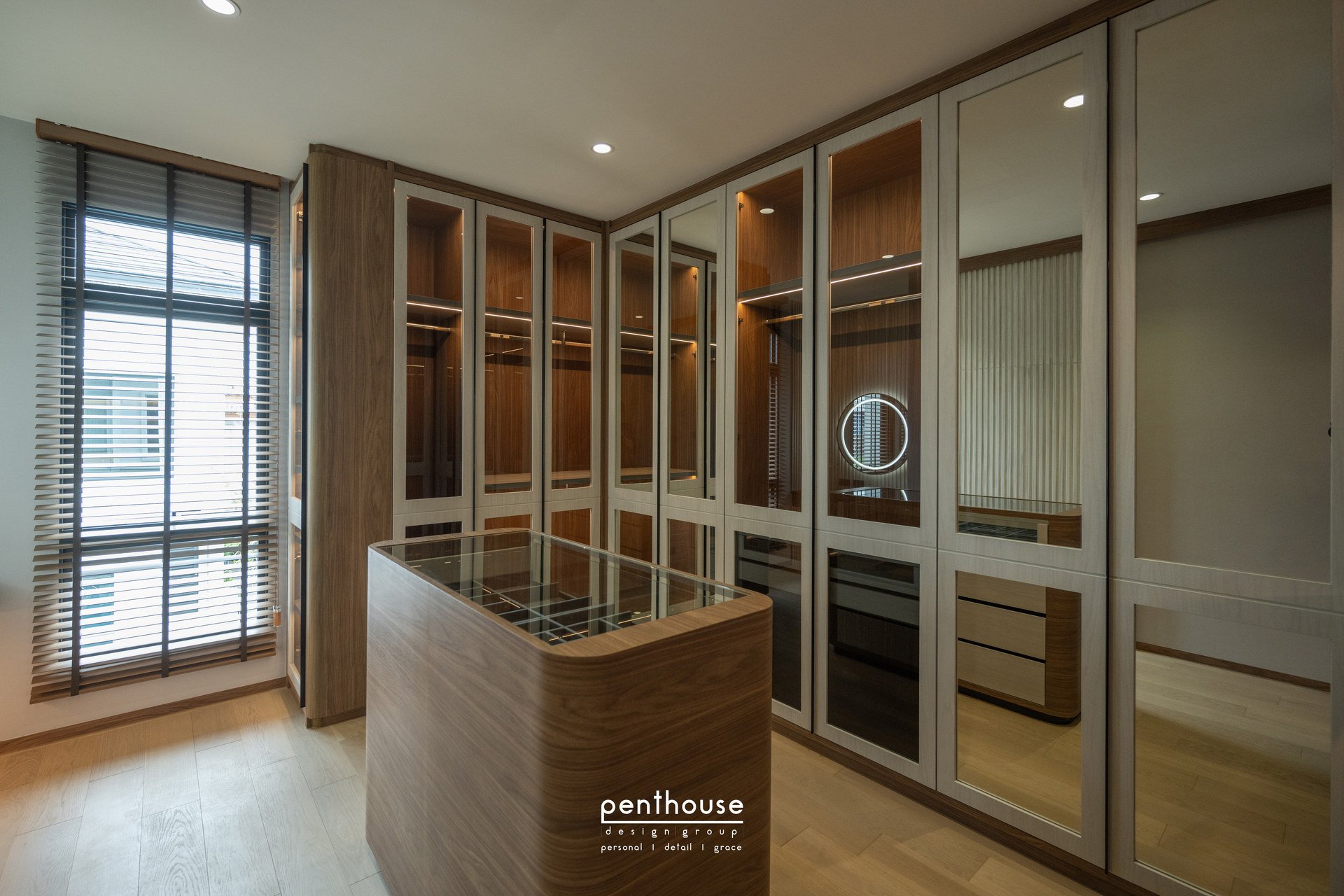 Real Theera House dressing room with perimeter wardrobes, a central cabinet and some visible internal compartments