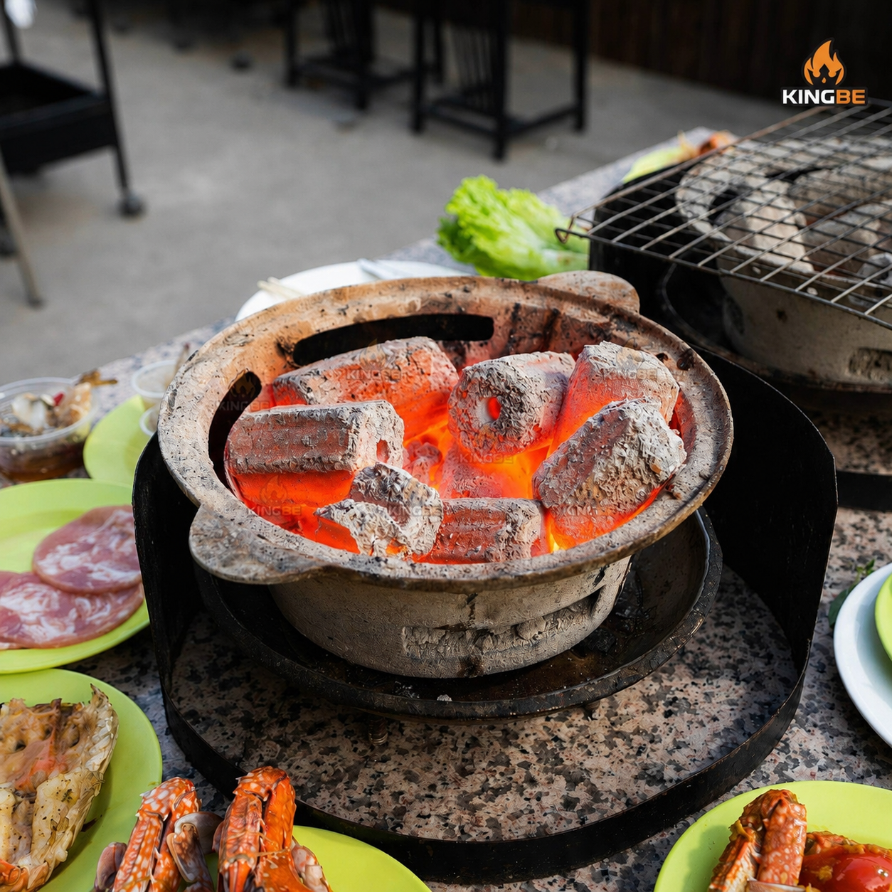 Charcoal stacked into a cone in a mookrata grill with a clear bottom vent, so air can travel up through the pieces
