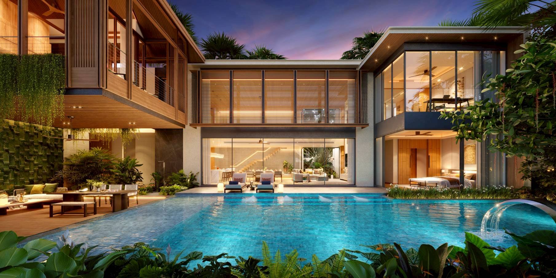 A PK Life pool villa in Cherng Talay at dusk, the interior lit and the pool reflecting the house