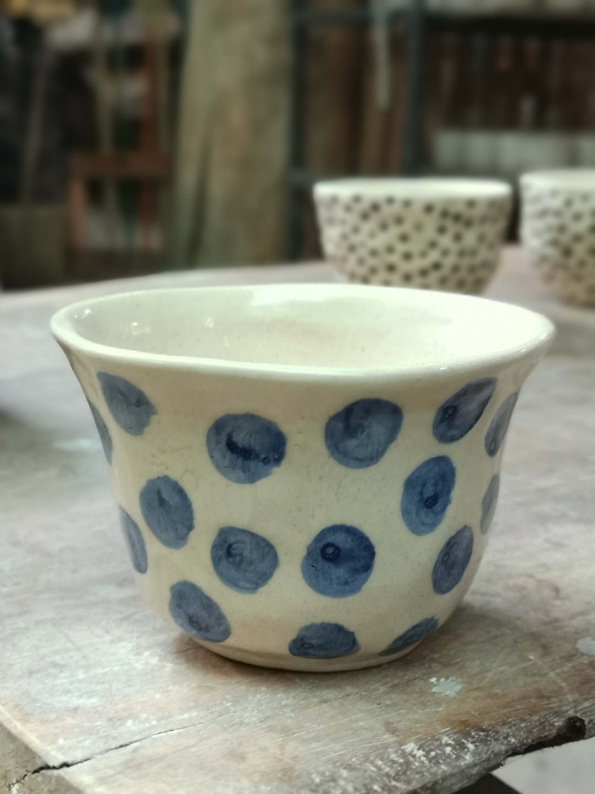 Terracotta plant pot with light blue polka dots