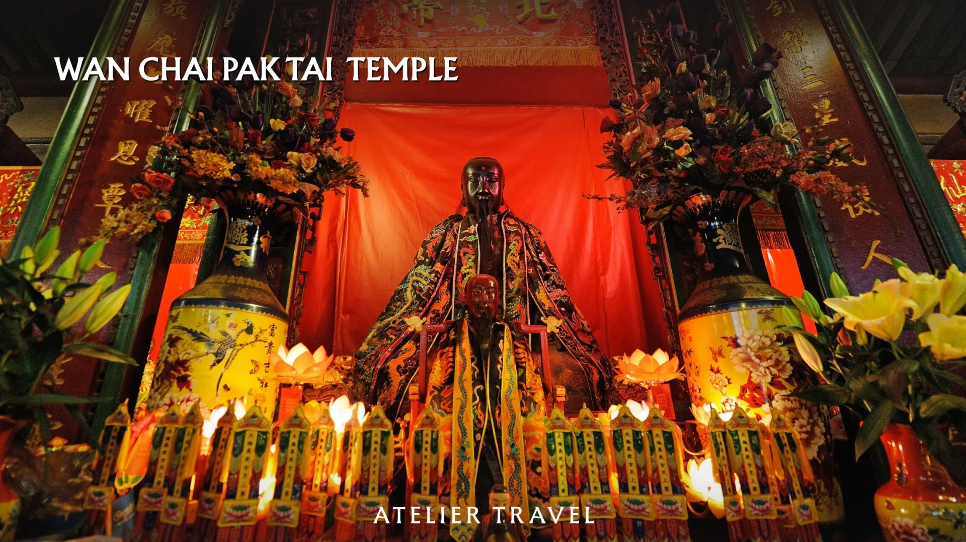 Deity statue, flowers and vases on the altar at Wan Chai Pak Tai Temple