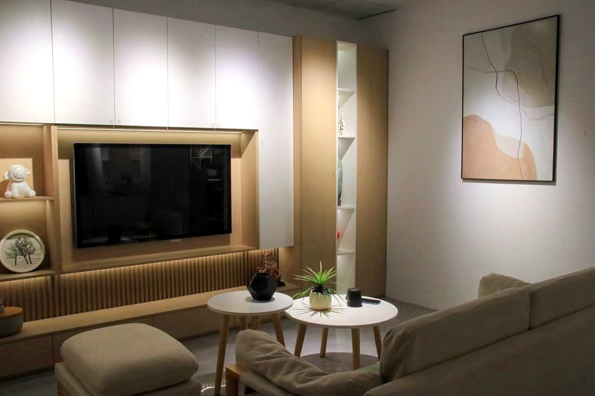 fync showroom with a warm wood-tone TV wall and built-ins