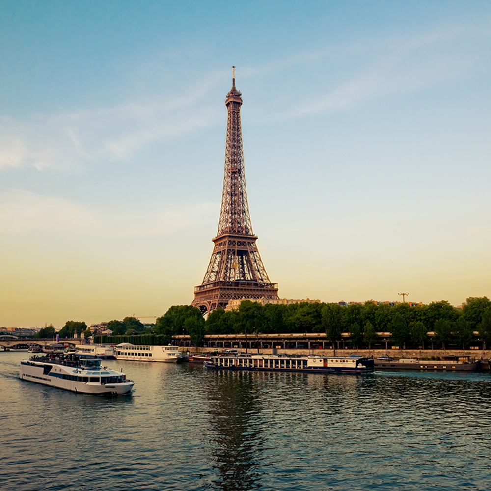 Effel Tower with boats in evening Paris, France