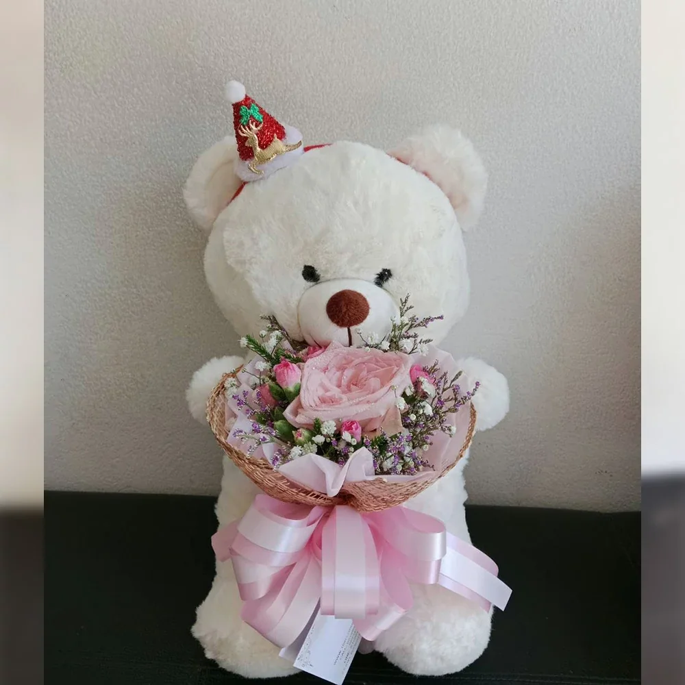 White bear holding pink flowers