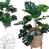 ต้นมอนสเตอร่าปลอมในตะกร้าหวาย ขาตั้งไม้ Artificial monstera plant in a wicker basket, wooden stand
