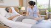 Nurse helping an older adult reposition safely to prevent pressure injuries at Khunkha Nursing Home Nurse helping an older adult reposition safely to prevent pressure injuries at Khunkha Nursing Home