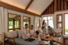 A family in the living pavilion, daylight coming in from windows on both sides