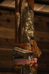 Lengths of coloured cloth wrapped around an old timber post