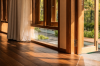 Open timber doors with light falling across the wooden floor and the garden beyond