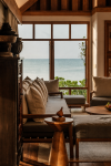A seating area framed by the doorway, looking through to the sea