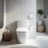 White toilet with the lid up and a plant