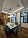 Dining room with a rectangular table, upholstered chairs, and wooden display shelves