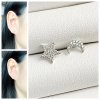 A tiny pair of star and moon diamond earrings, made of real silver.
