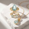 Sterling Silver Sky Blue Topaz & White Zircon Bow Ring Over 18K Yellow Gold Plated