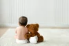 Baby and teddy bear rear