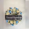 Wreath of fresh flowers mixed with artificial flowers