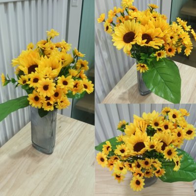 อดอกทานตะวันปลอมประดิษฐ์แจกันแก้ว Artificial sunflowers in a glass vase.