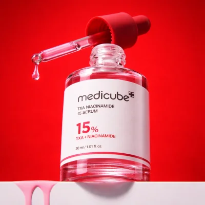 Close up of Medicube TXA Niacinamide 15 Serum dropper showing texture of brightening serum with tranexamic acid and niacinamide