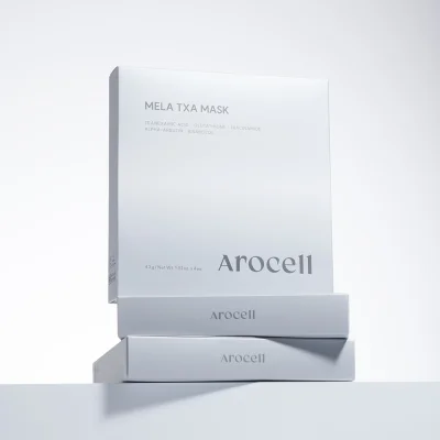 กล่องมาส์ก AROCELL MELA TXA MASK วางซ้อนกัน 3 กล่อง บนพื้นสีขาว
