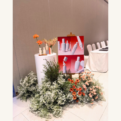 Warm orange floral installation by Le Floriste for Sulwhasoo Bounce to Youth wellness event and marketing activation in Bangkok.