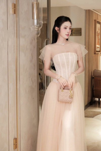 เดรสยาวสีชมพูเกาะอกตกแต่งผ้าซีทรูที่ไหล่และโบว์คริสตัล