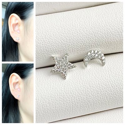 A tiny pair of star and moon diamond earrings, made of real silver.
