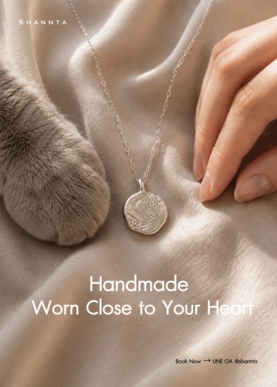 Handcrafted 99.99% fine silver pendant with cat paw print texture alongside cat paw Shannta