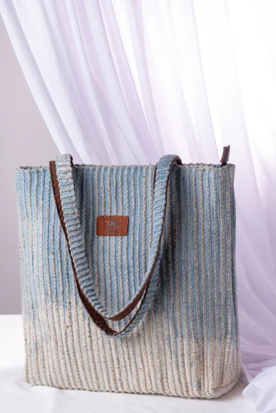 กระเป๋าสะพายฝ้ายย้อมครามผสานเส้นผักตบชวา Indigo-dyed cotton shoulder bag combined with water hyacinth fibers.