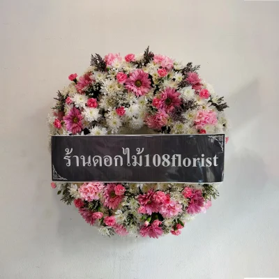 Wreath of fresh flowers mixed with artificial flowers