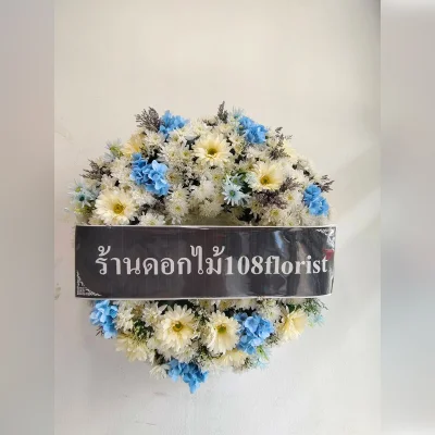 Wreath of fresh flowers mixed with artificial flowers
