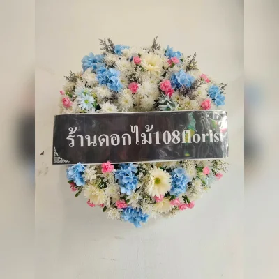 Wreath of fresh flowers mixed with artificial flowers