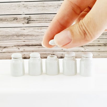 Set of 5 miniature white ceramic canisters with lids, ideal for dollhouse kitchens or decorative displays, handmade with intricate details.