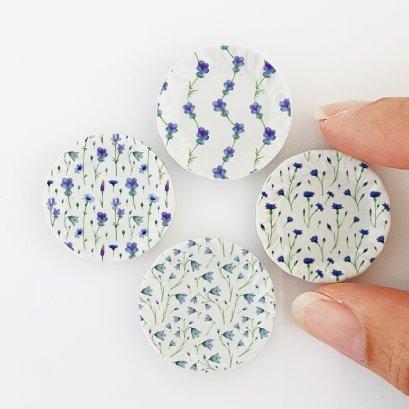 Miniature ceramic decorative plates with intricate purple floral patterns, ideal for dollhouse kitchens, collectible mini dish sets, and charming tiny home decor.