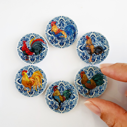 Miniature ceramic plates with classic rooster and floral designs, ideal for rustic farmhouse dollhouse kitchens or as collectible miniatures.