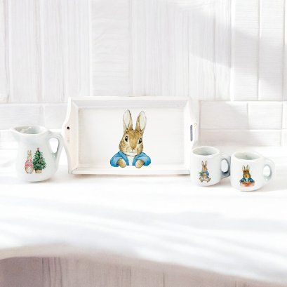 Miniature bunny tea set featuring a ceramic tray, pitcher, and two mugs with Peter Rabbit designs, perfect for dollhouse decor and collectors.