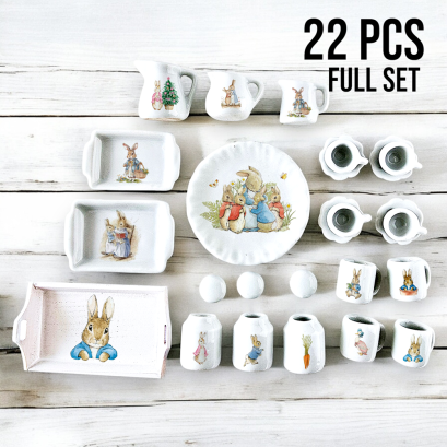 Complete 22-piece miniature Peter Rabbit kitchen set, featuring trays, mugs, plates, and jars, perfect for dollhouse decor and collectors.