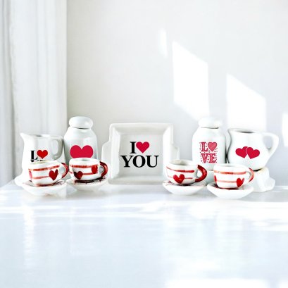 Miniature Valentine's tea set featuring ceramic cups, pitchers, and trays with heart designs, perfect for dollhouse decor or 1:12 scale collections.