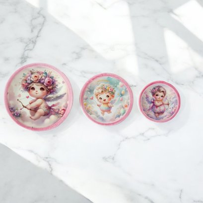 Set of three miniature ceramic plates featuring adorable angel designs with pastel pink rims, perfect for dollhouse decor or collectible gifts.