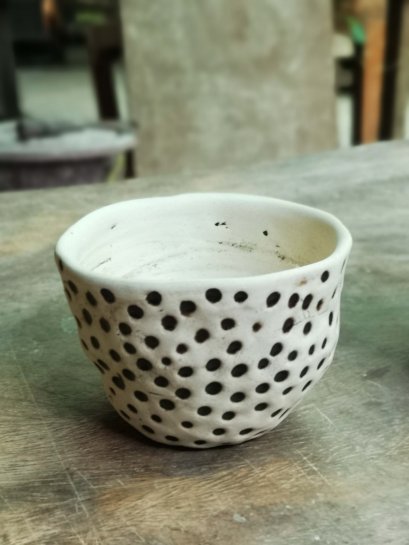 Terracotta plant pot with black polka dots