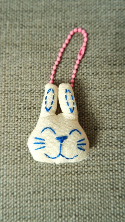 White rabbit keychain, pink cord