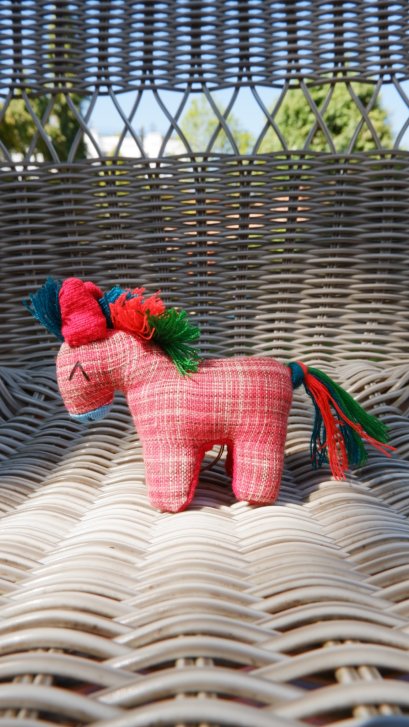 Red horse keychain with blue, green orange tail